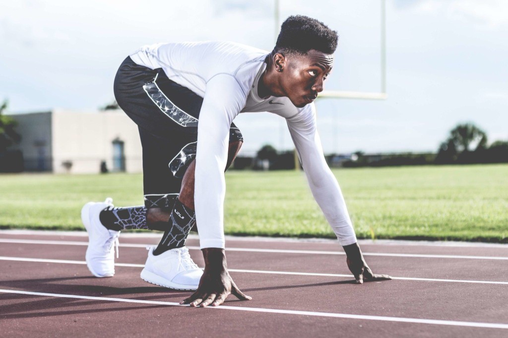Athlete in starting position on a running track